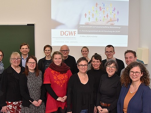 TRAWOS employees as a group in front of a beamer projection in a seminar room