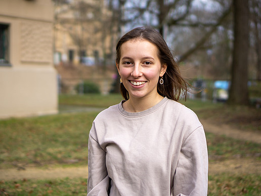 Luisa Walter sits in the park and smiles at the camera.