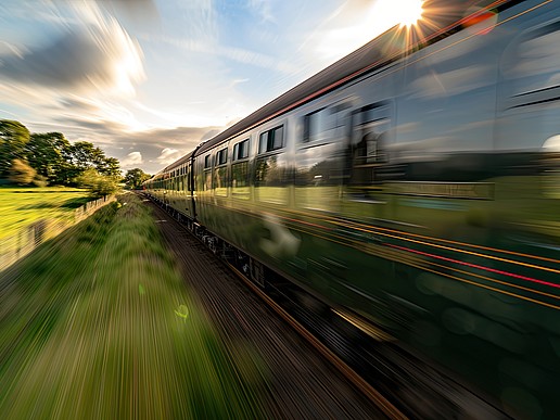 An express train travels through a green landscape